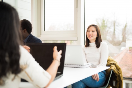 A brunette women working on laptop